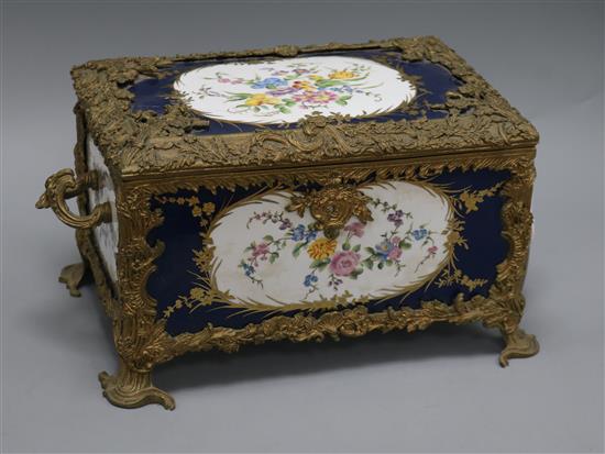 A porcelain and brass mounted casket length 39cm